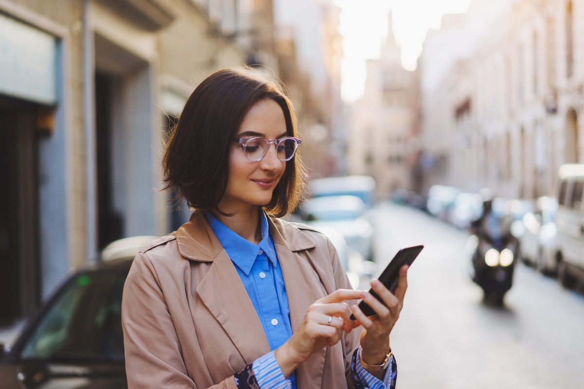 person on phone with motorbike in the background