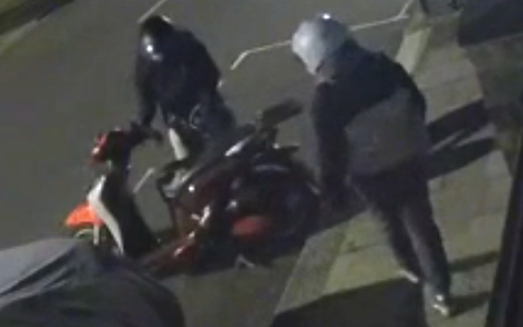 CCTV image of two people parking moped