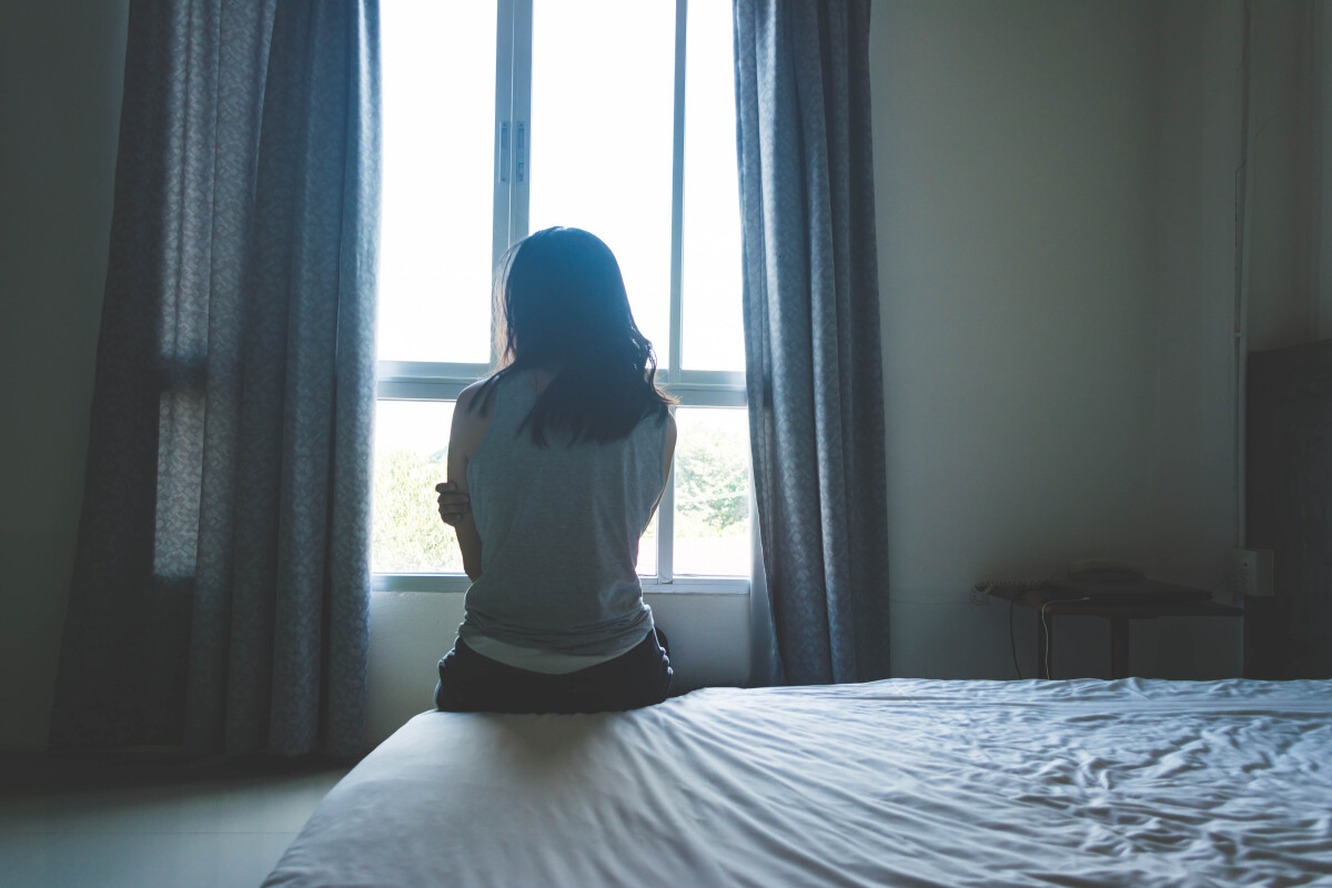 Woman sitting on bed