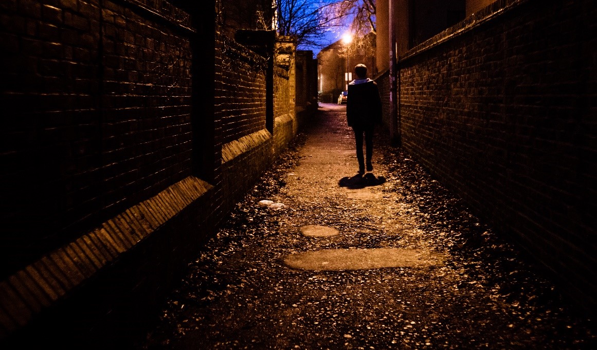 Boy in dark alleyway
